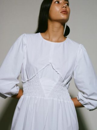CAES model wearing a white dress