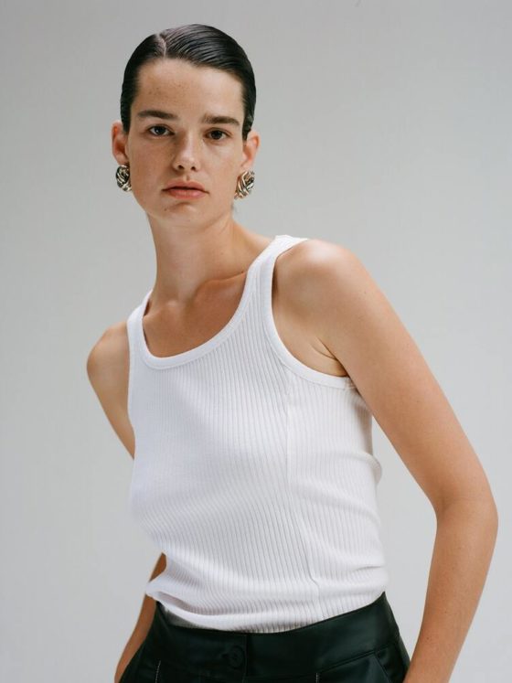 CAES model wearing a white tank top