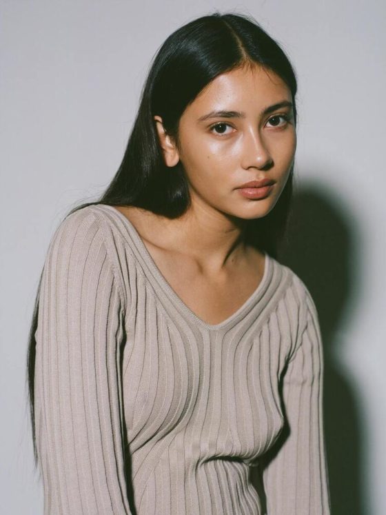 CAES model wearing a ribbed-knit sweater in organic cotton