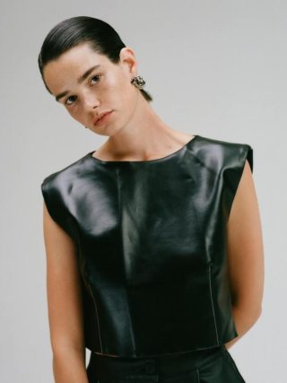 CAES model wearing Vegea leather crop top that is made of fruit pulp, which is waste from the wine industry