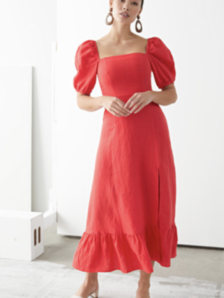 woman poses in red dress with puff sleeve