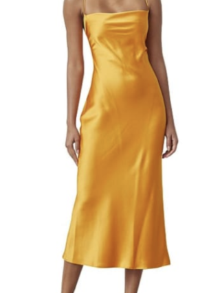 woman poses in rented sustainable golden yellow midi length dress