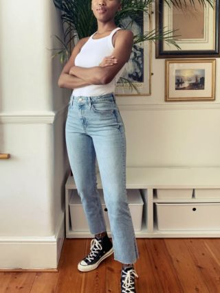 Woman stands modelling Topshop split hem jeans