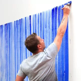 Jeppe Hein painting "Breathing Watercolours" on a wall