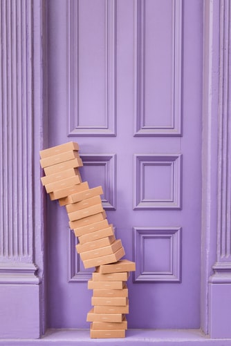 brown boxes against purple door
